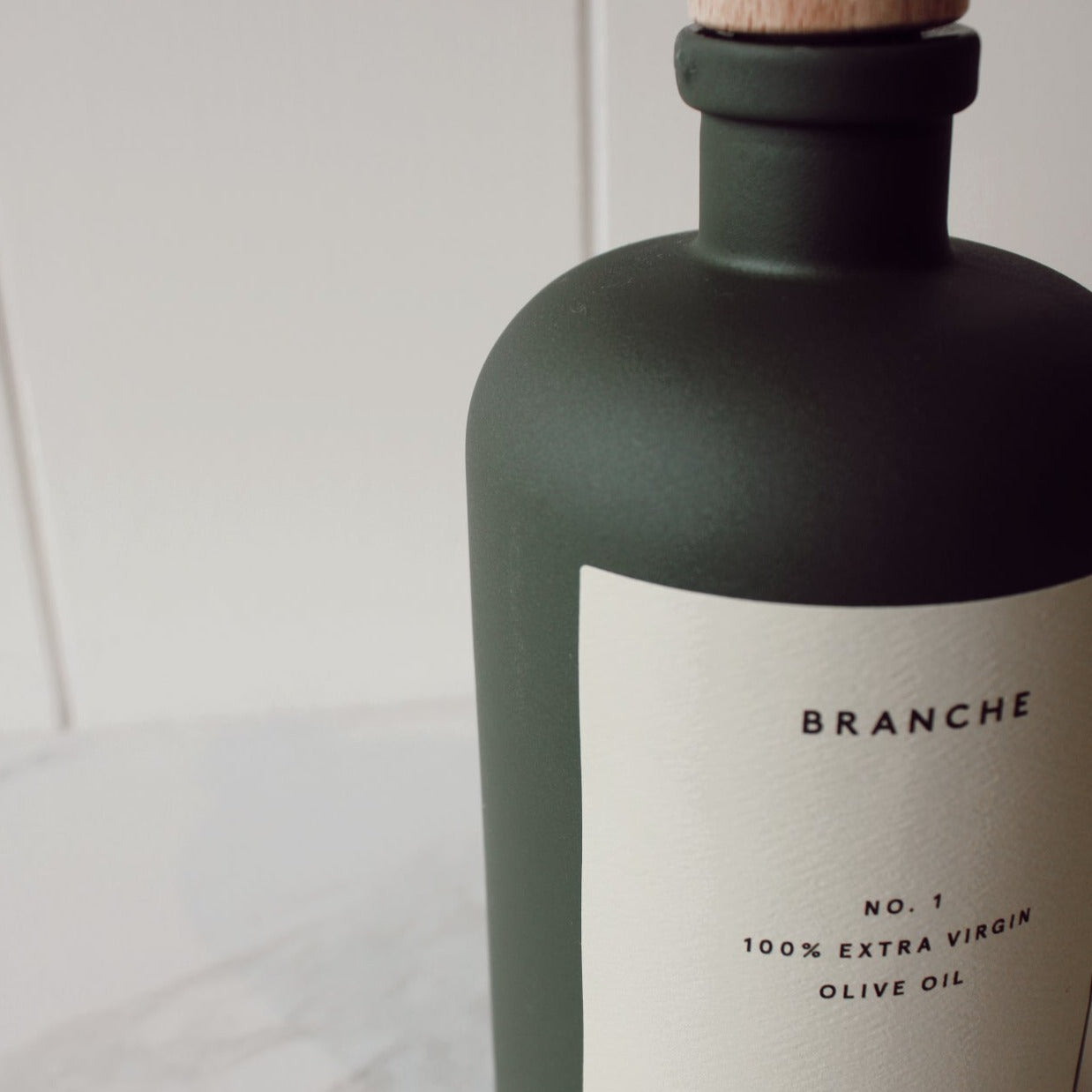 Branche Number One Olive Oil in Dark Green Matte Bottle Pictured Up Close