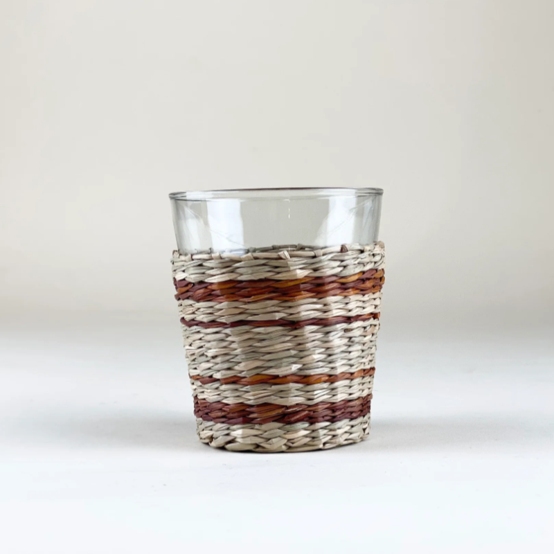 striped rattan tumbler pictured against a blank wall