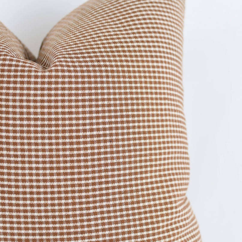 Georgia Rust Pillow pictured up close to show checkered pattern detail 