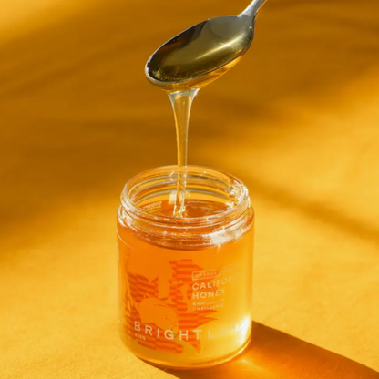 Open Jar of California Orange Honey with Spoon Scooping 