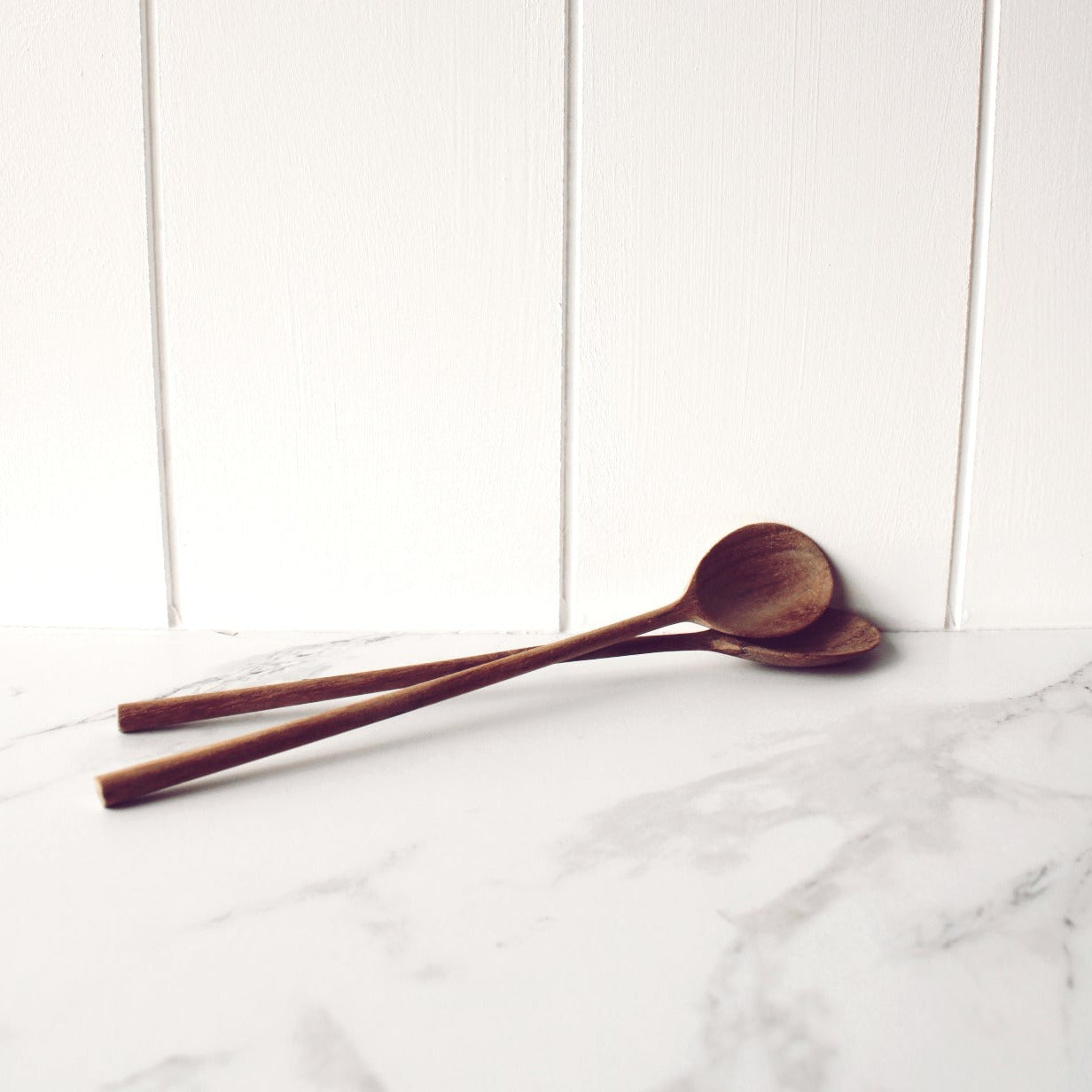 Two wooden cafe latte spoons stacked